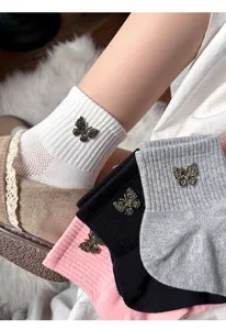 Close-up detail of women mesh short socks with rhinestone butterfly charm, soft ankle socks.