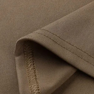 Close-up detail of smooth knit fabric showing fine stitching texture and neat hemline.