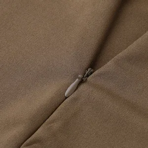 Close-up detail view of brown slim dress fabric featuring a neat matching zipper.