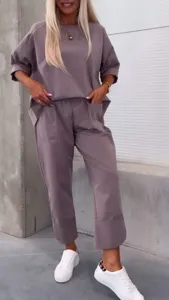 Detail shot of casual loose two-piece outfit featuring a round neck top and cropped pants.