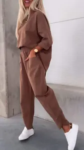 Casual brown two-piece set featuring an oversized crewneck top and cropped pants for women.