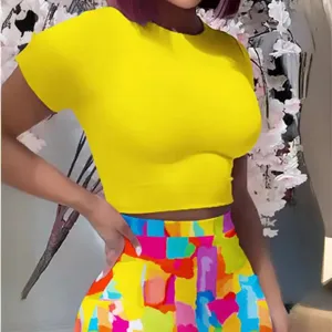 Sexy two-piece outfit featuring a bright yellow crop top and colorful abstract print skirt.