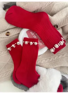 Red ribbed knit mid-tube socks featuring delicate pearl flower details, cozy winter detail.