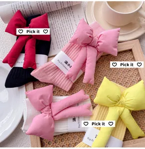 Cozy knit socks featuring large 3D stuffed bows, soft cotton texture, stylish autumn detail.