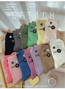 Colorful stackable mid-tube socks with cute smiley faces and number prints for women autumn winter.