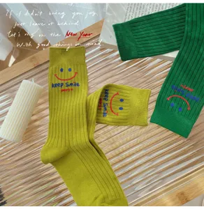 Women's ribbed knit crew socks with cute smiley face and letter print for autumn winter.