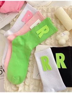 Detail view of colorful mid-calf socks with letter patch, soft and stylish daily wear.