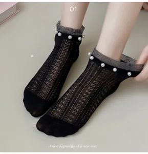Detailed view of women's black mesh ankle socks featuring elegant pearl decor and ruffled trim.