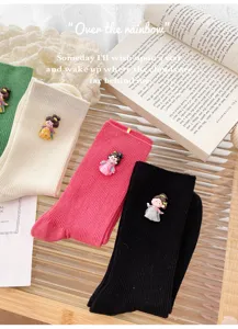 Detail view of cute Chinese style cartoon doll accessories on fine ribbed cotton stack socks.