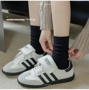 Close-up shot of ribbed mid-tube socks paired with stylish casual sneakers for daily wear.