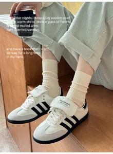 Detail shot of solid color ribbed mid-tube socks paired with stylish casual athletic sneakers.