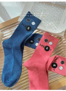 Fall winter cute mid-tube stacked socks with smiley face and number print, casual knit hosiery.