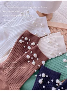 Detail view of women's knitted socks with pearl decor, showing soft fabric and fine texture.