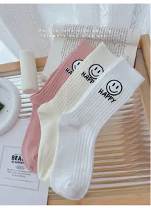 Detailed view of cozy striped crew socks featuring cute happy smiley face print.