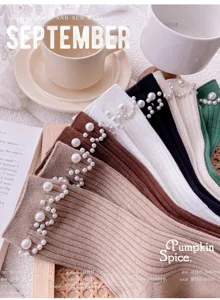 Close-up of stylish knit mid-tube socks featuring elegant pearl embellishments and ribbed fabric.