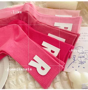 Pink mid-calf socks for women featuring white letter R patches, sweet style and soft knit.