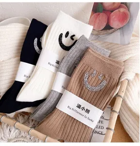 Detail shot of Korean style rhinestone smiley ribbed crew socks texture and soft fabric.