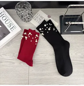 Pearl embellished knit socks detail shot showing fine ribbed texture and elegant beaded design.