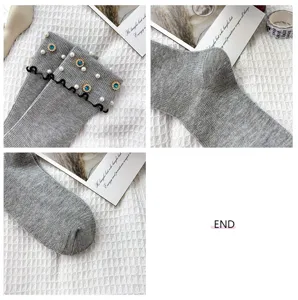 Women grey mid-tube socks with pearls blue rhinestones and elegant black lettuce edge detail.