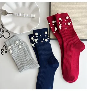 Detailed view of women knit mid-tube socks featuring elegant pearl embellishments and rich colors.