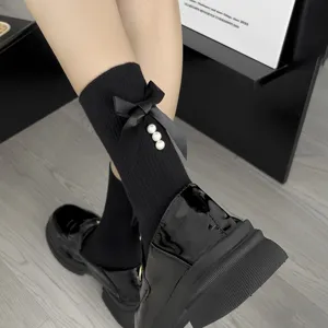 Cute black mid-tube socks featuring a satin bow and pearls for sweet Japanese style daily wear.