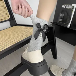Grey mid-calf socks with black bow and pearls, sweet preppy style knit hosiery for women.