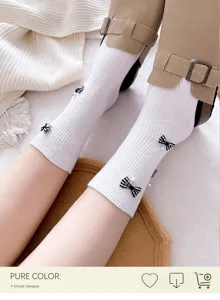 White mid-calf socks featuring sweet black and white plaid bows and delicate pearl decorations.