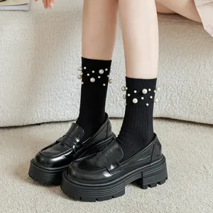Women black mid-tube cotton socks with pearl beaded design paired with platform loafers main view