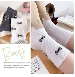 Detail shot of women's mid-tube socks featuring cute plaid bows and elegant pearl decorations.