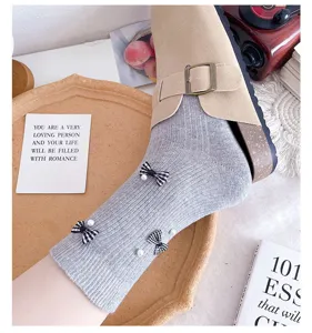 Grey ribbed mid-tube socks for women featuring plaid bows and elegant pearl decorations.