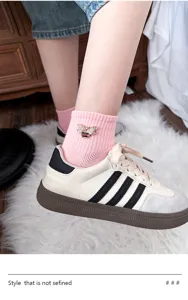 Close-up detail of rhinestone bee brooch on pink mesh cotton short sock, stylish college style.