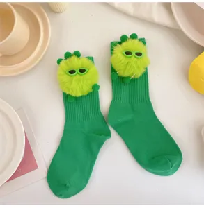 Cute green monster plush detail socks, funny doll design mid tube socks for girls daily wear.