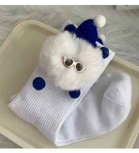 Cute white mid-tube socks featuring a fluffy plush doll with a blue knit hat and tiny sunglasses.