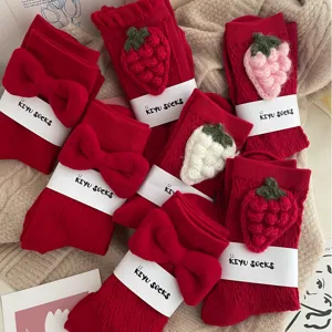 Red cotton mid-calf socks featuring cute 3d knit strawberries and bows for sweet winter style.