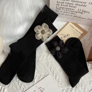 Women black mid tube socks featuring 3d organza flower and rhinestone accent cozy winter hosiery