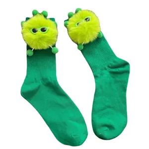 Cute green mid-calf socks with fluffy plush doll monster decoration, stylish and fun for women.