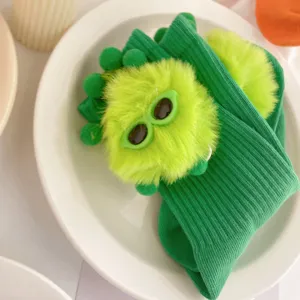 Cute green girls mid-tube socks with fluffy plush elf toy detail, top view main product shot