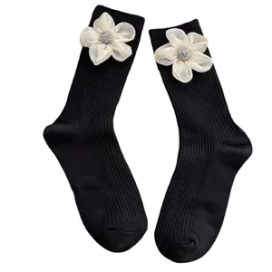 Women's black mid-calf socks featuring 3d organza flower and sparkly rhinestone center design.