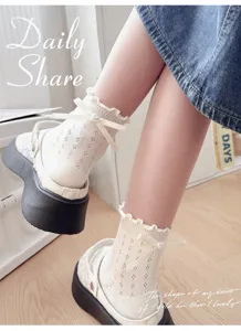 Detail shot of sweet Lolita mesh short socks with cute bow and heart charm for women.