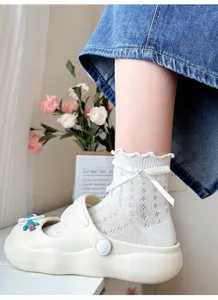 Close-up detail of white lace mesh bow short socks paired with shoes, summer sweet style.