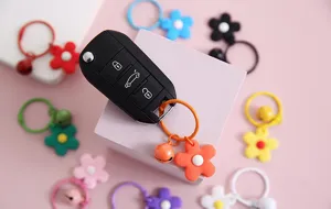 Kleurrijke madeliefje sleutelhangers met kleine belletjes, leuk accessoire voor tassen.
