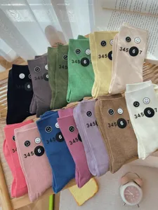 Cute colorful slouch socks for women, winter autumn casual style with smile face and number prints.