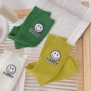 Korean style cute smiley face printed mid-calf socks for women, cozy thick striped design.