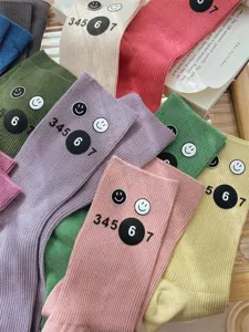 Colorful ribbed crew socks with cute smiley face and number print, casual fall winter hosiery.