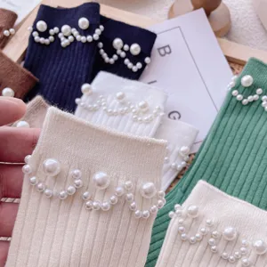 Ribbed knit mid-tube socks for women featuring elegant pearl wave decoration. Cute and trendy.