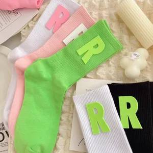 Cute women's mid-tube socks featuring a bold R letter patch, sweet JK style fashion hosiery for daily wear.