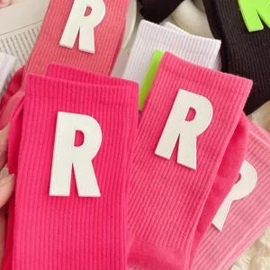 Women's knitted mid tube socks with letter R patch, cute Japanese ins style pink long socks.