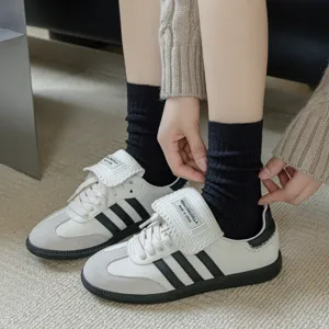 Trendy casual sneakers with contrast stripes and folded tongue matching black socks for daily wear.