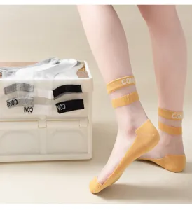 Detail view of sheer crystal silk socks with double stripes and non-slip cotton bottom.