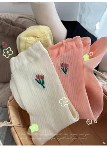 Cute Japanese style women mid tube socks with sweet tulip embroidery and ruffled design, soft cotton.